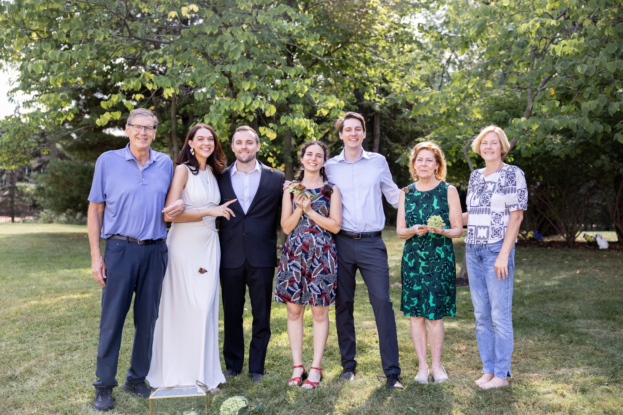 The family lined up on the lawn at Ashley and Mark's wedding, the bride and groom in the middle