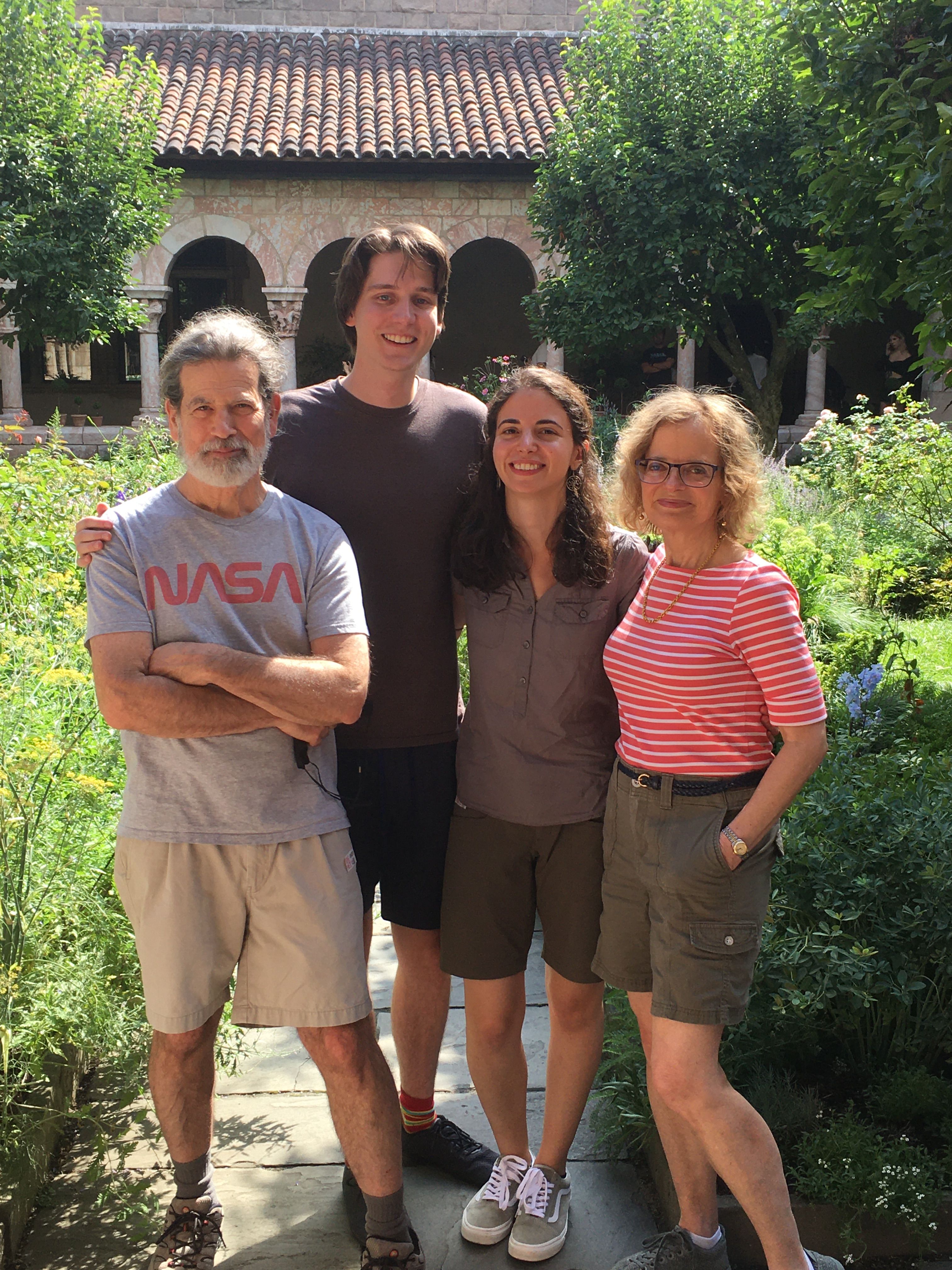 Katherine and Johnny with family in a sunny courtyard garden