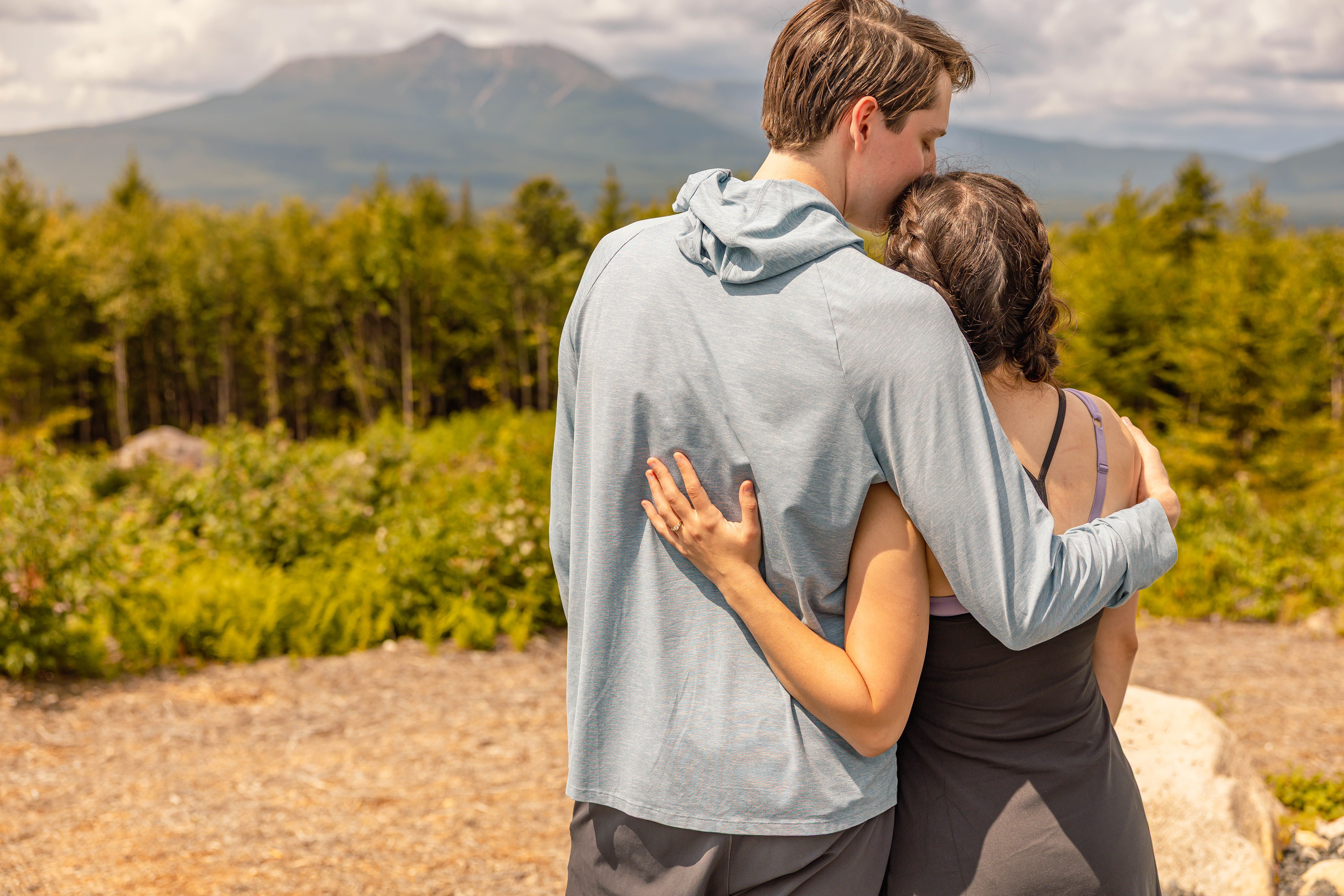 Katherine and Johnny embracing at a mountain overlook