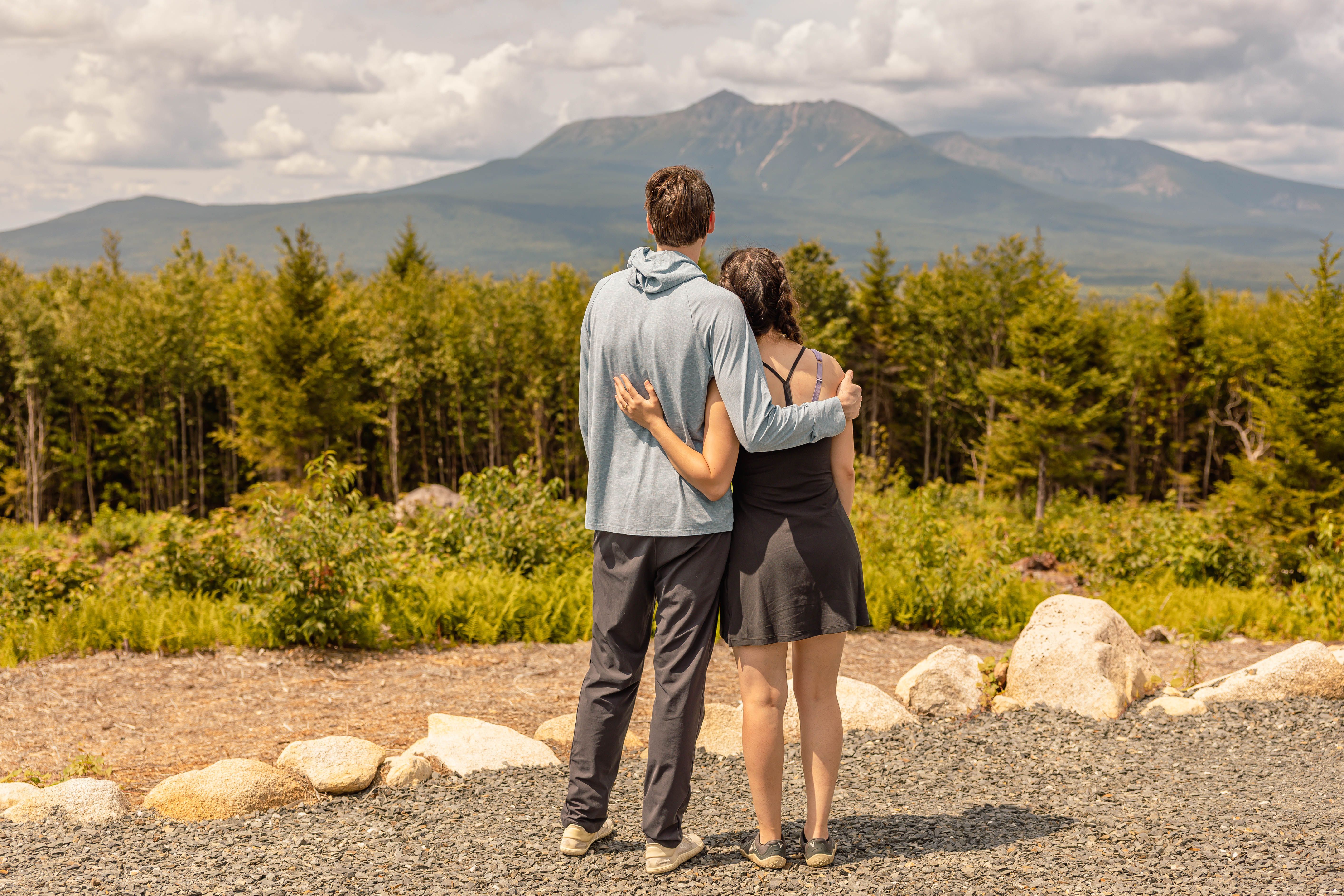 Katherine and Johnny standing together, looking out toward the mountains