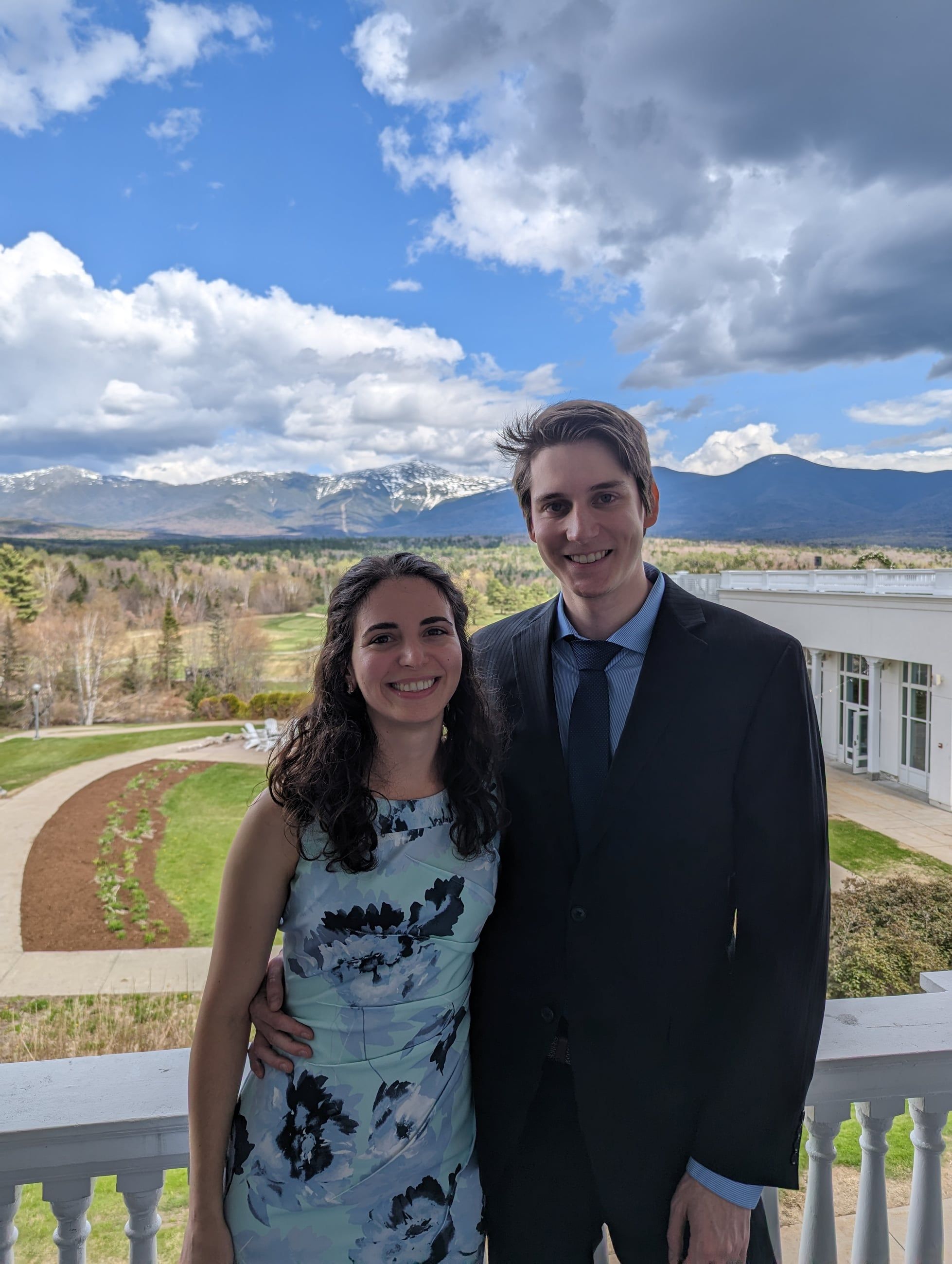 Katherine and Johnny dressed for a wedding, the Presidential Range behind them