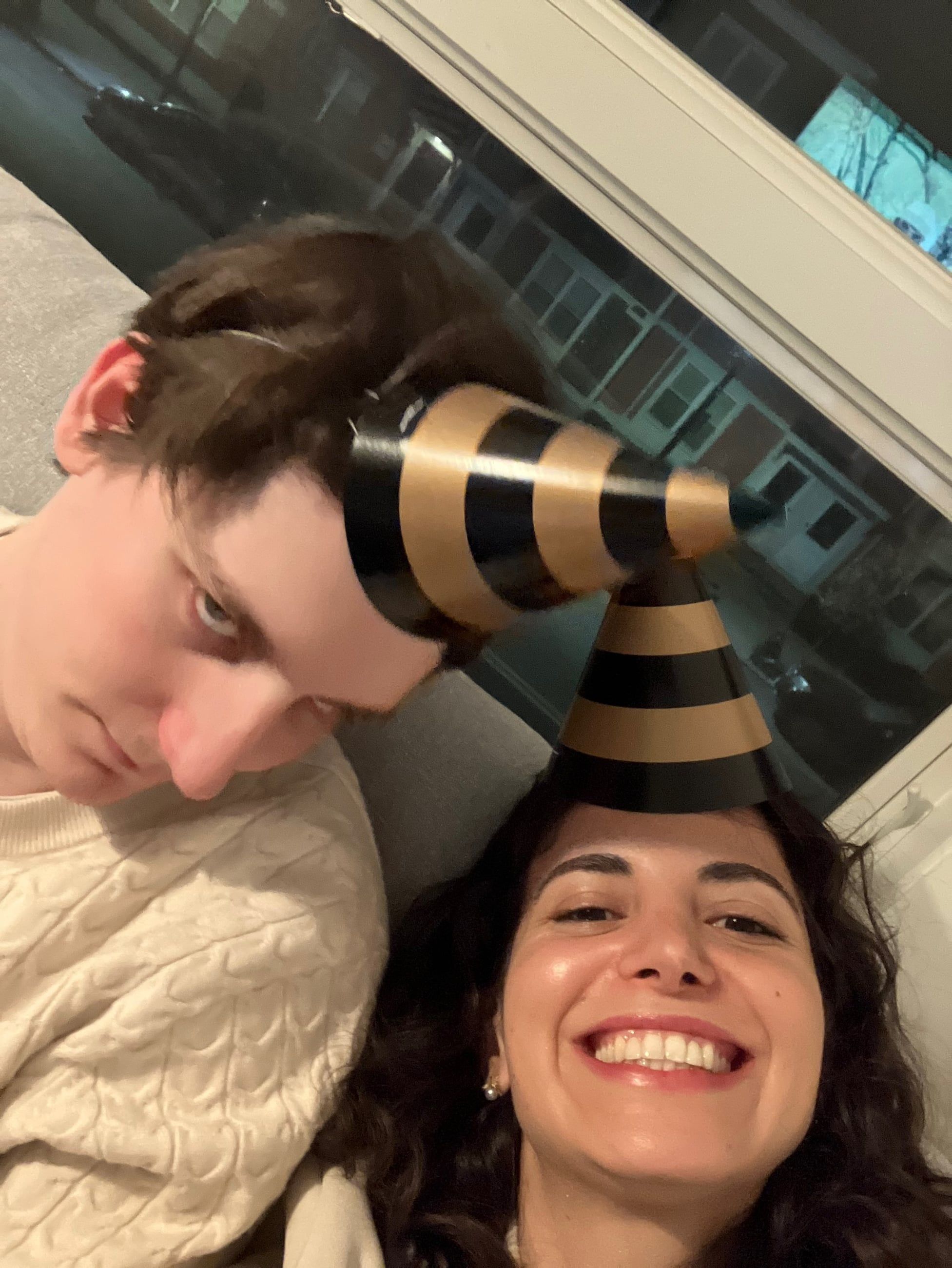 Katherine and Johnny in party hats on New Year's Eve